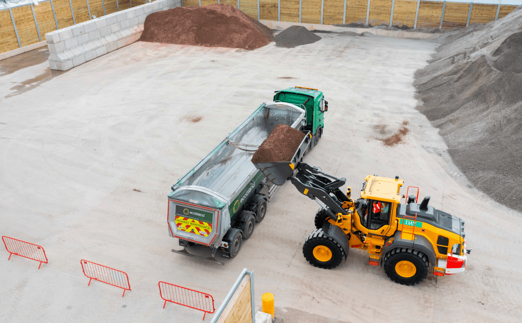 a tractor loading a truck